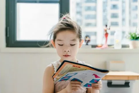 preschooler looking at book